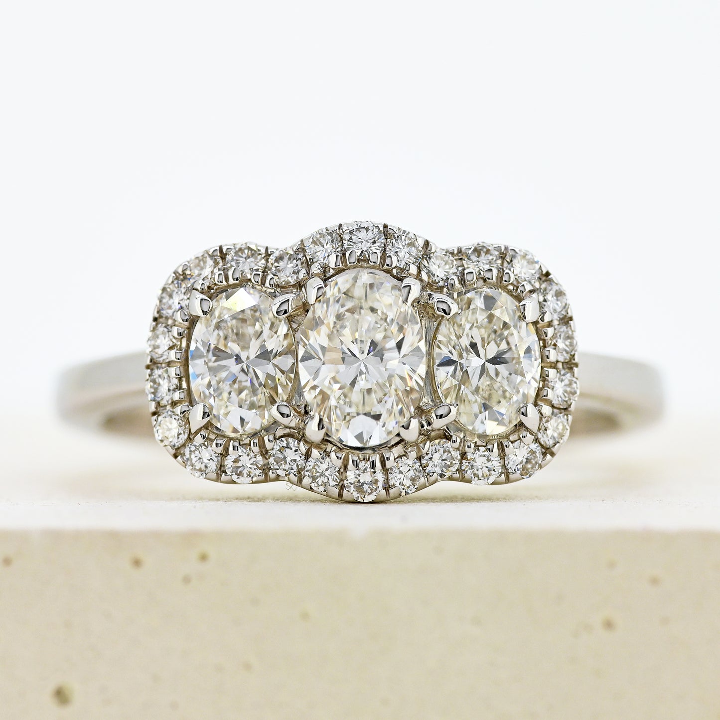 diamond three stonr, 18ct diamond three stone, diamond three stone cluster, oval diamond three stone, 18ct oval three stone with diamond surround