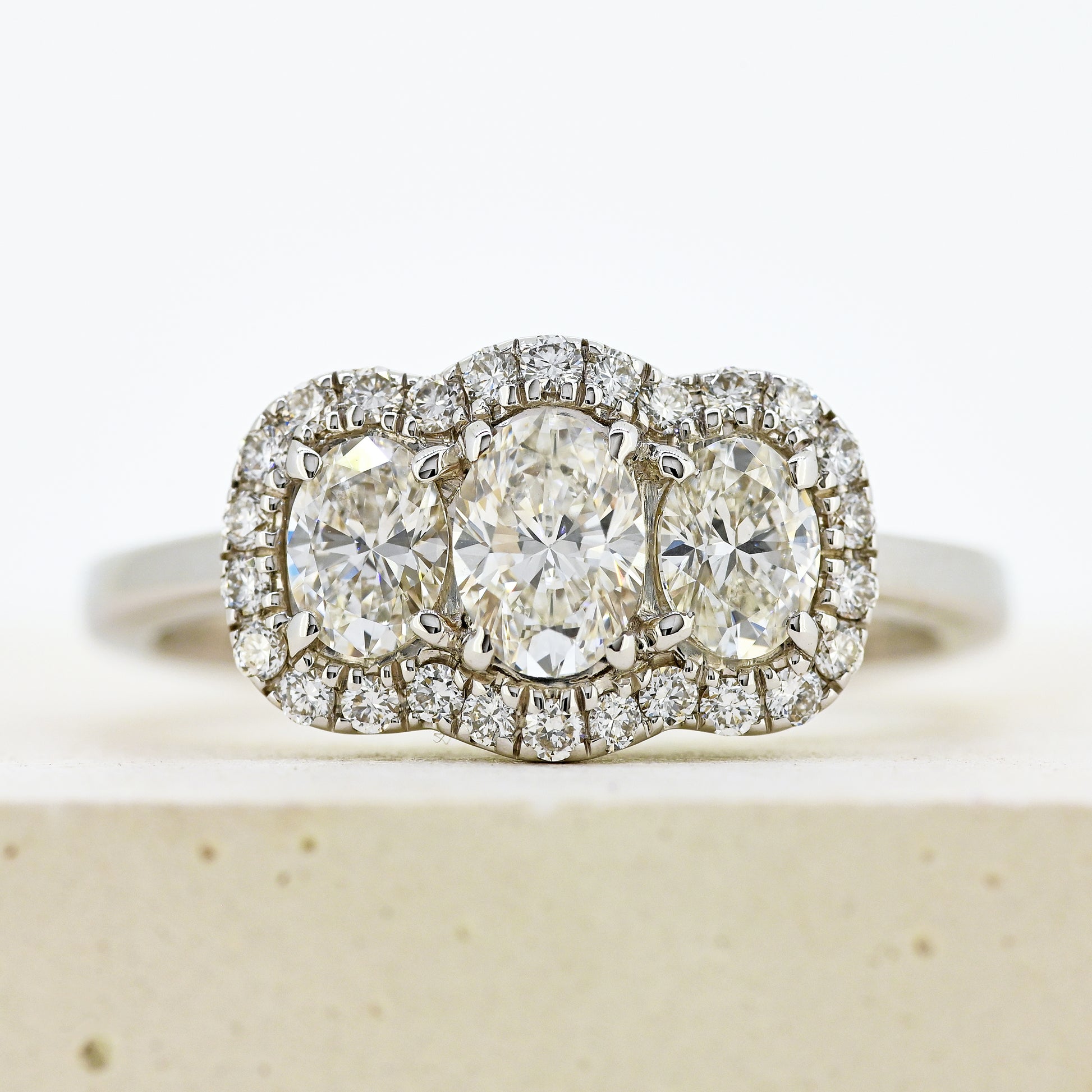 diamond three stonr, 18ct diamond three stone, diamond three stone cluster, oval diamond three stone, 18ct oval three stone with diamond surround