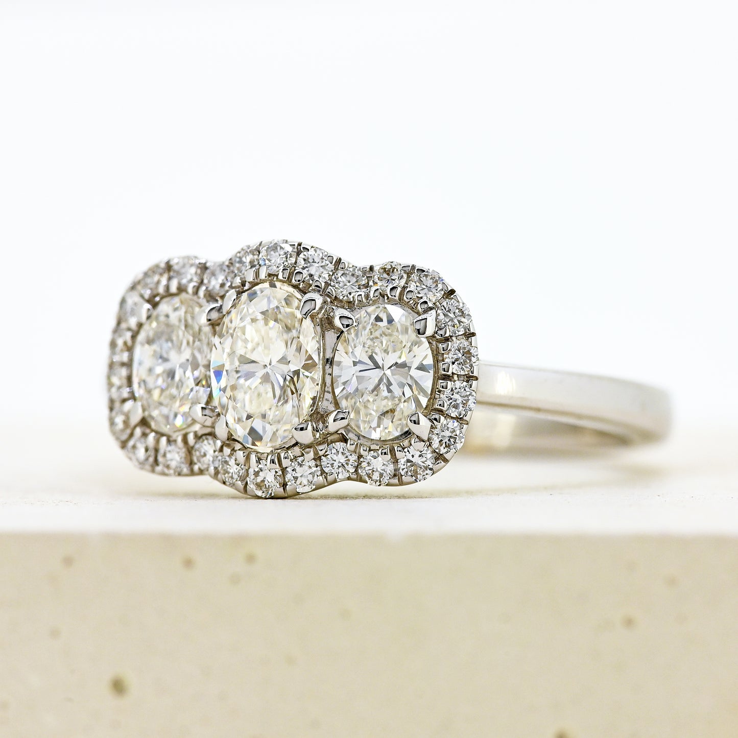 diamond three stonr, 18ct diamond three stone, diamond three stone cluster, oval diamond three stone, 18ct oval three stone with diamond surround