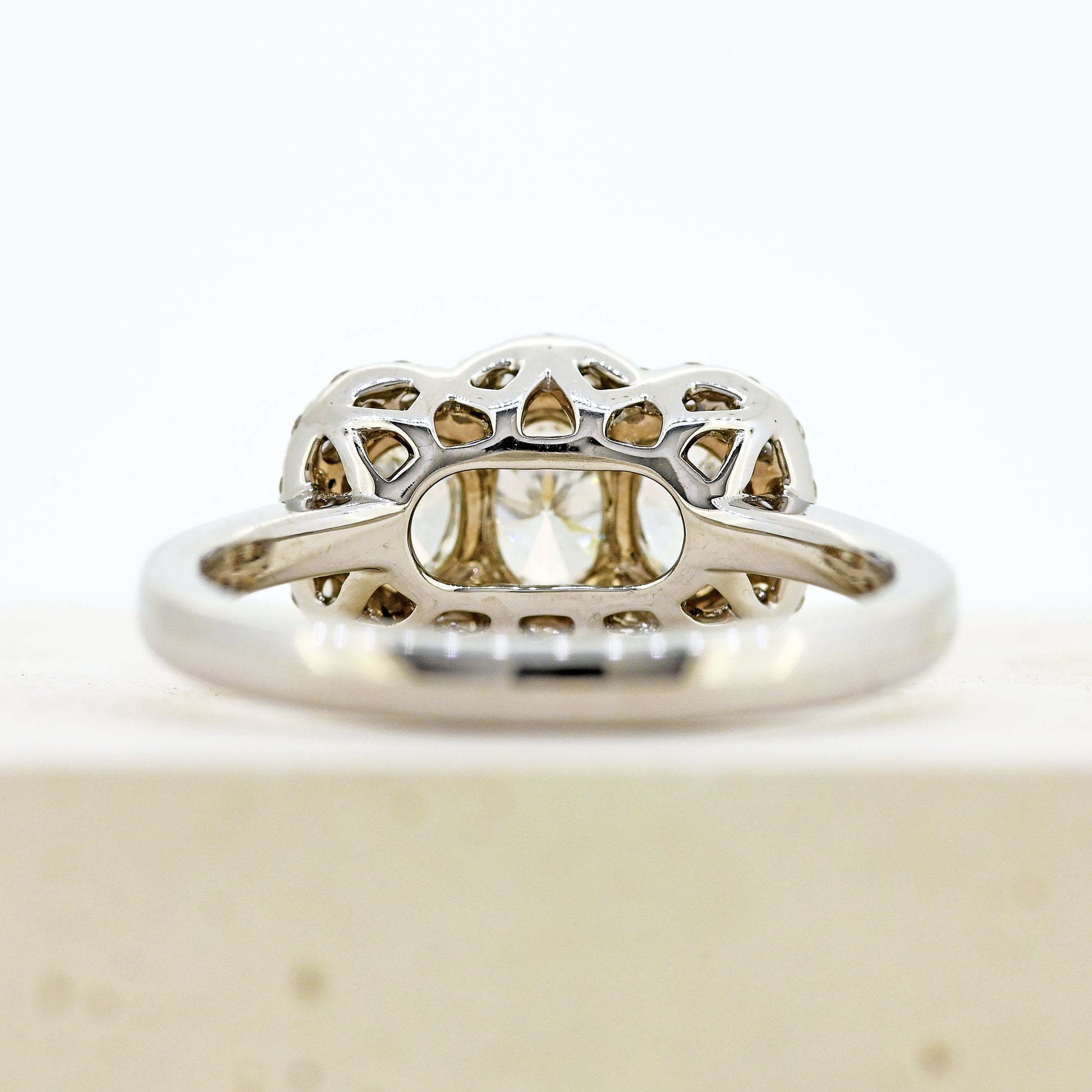 diamond three stonr, 18ct diamond three stone, diamond three stone cluster, oval diamond three stone, 18ct oval three stone with diamond surround