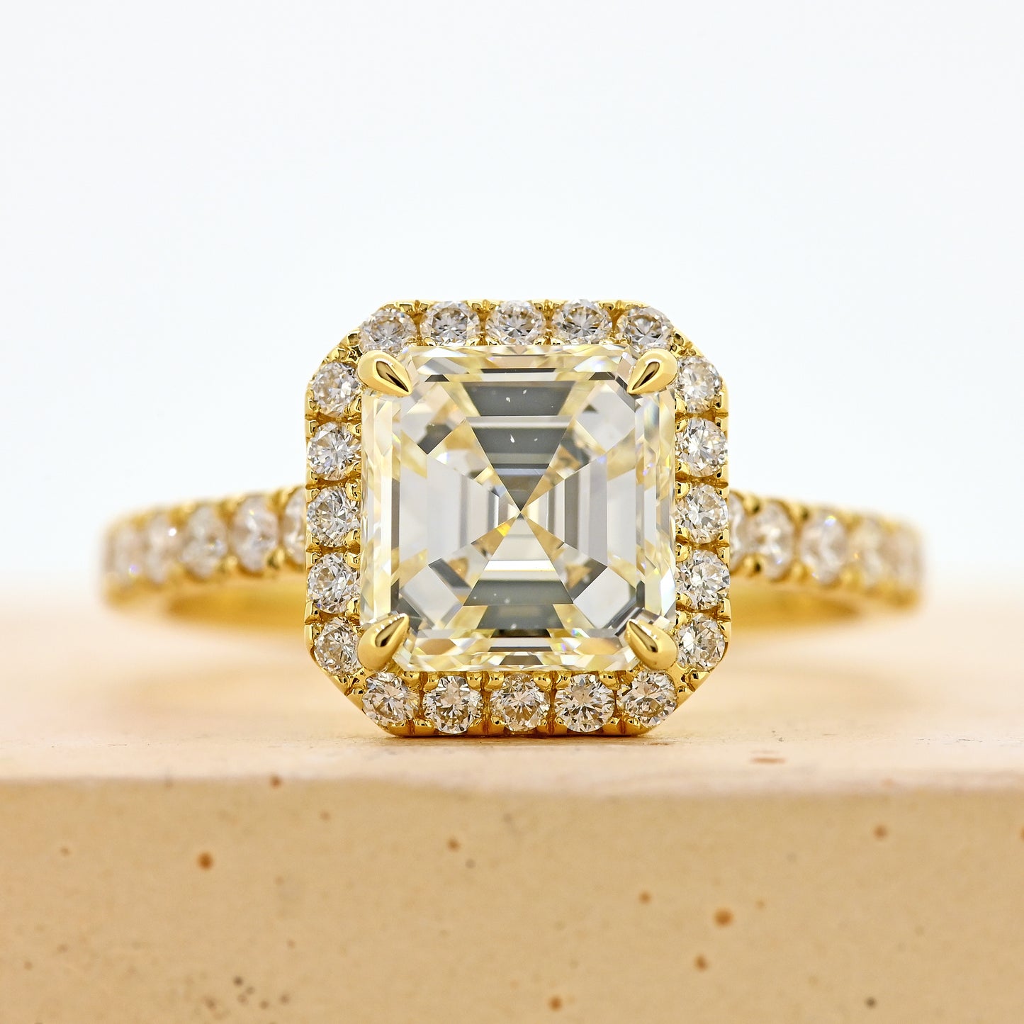 18ct asscher cut diamond ring, asscher diamond ring, asscher halo ring, asscher cut diamond ring with diamond shoulders, 18ct asscher halo ring with shoulder diamonds, 18ct yellow gold asscher cut diamond ring