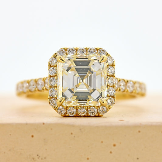 18ct asscher cut diamond ring, asscher diamond ring, asscher halo ring, asscher cut diamond ring with diamond shoulders, 18ct asscher halo ring with shoulder diamonds, 18ct yellow gold asscher cut diamond ring